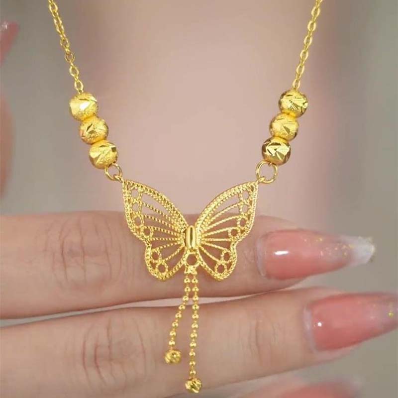 Norvo | Halskjede med gullfarget sommerfugl med dusker