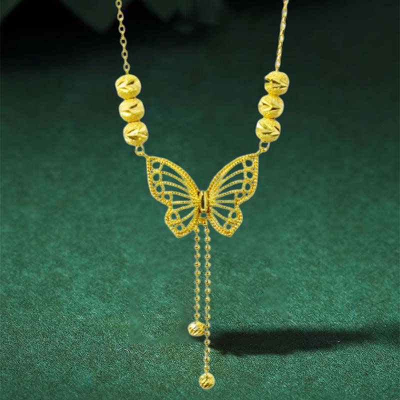 Norvo | Halskjede med gullfarget sommerfugl med dusker